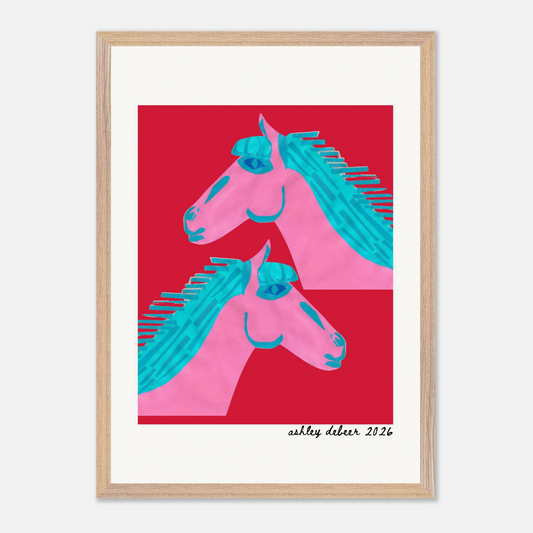 Framed artwork of two pink horses with blue manes on a red background, signed 'Ashley Deber 2026'.